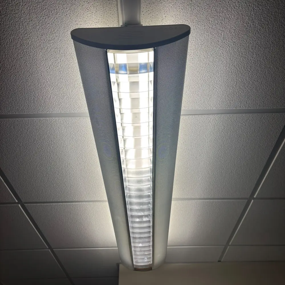 Linear LED light fitting in a suspended office ceiling